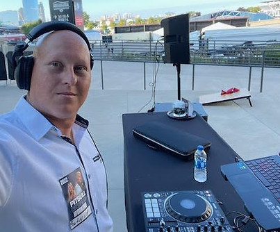 Joe, DJ Cubano, at an outdoor DJ booth