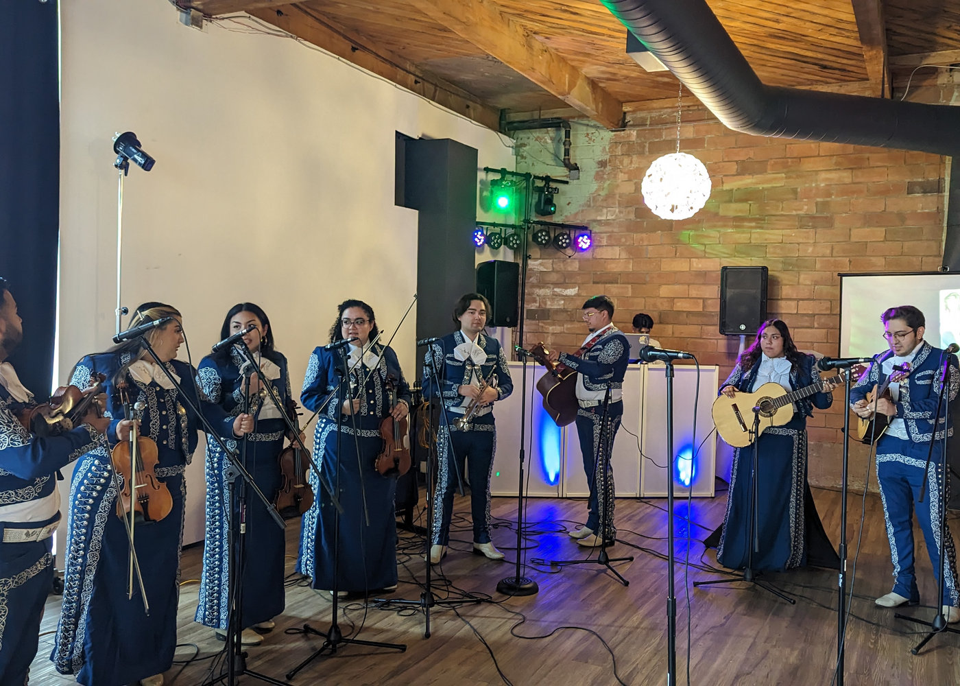 Mariachi musicians performing beside the Lex-G DJ booth