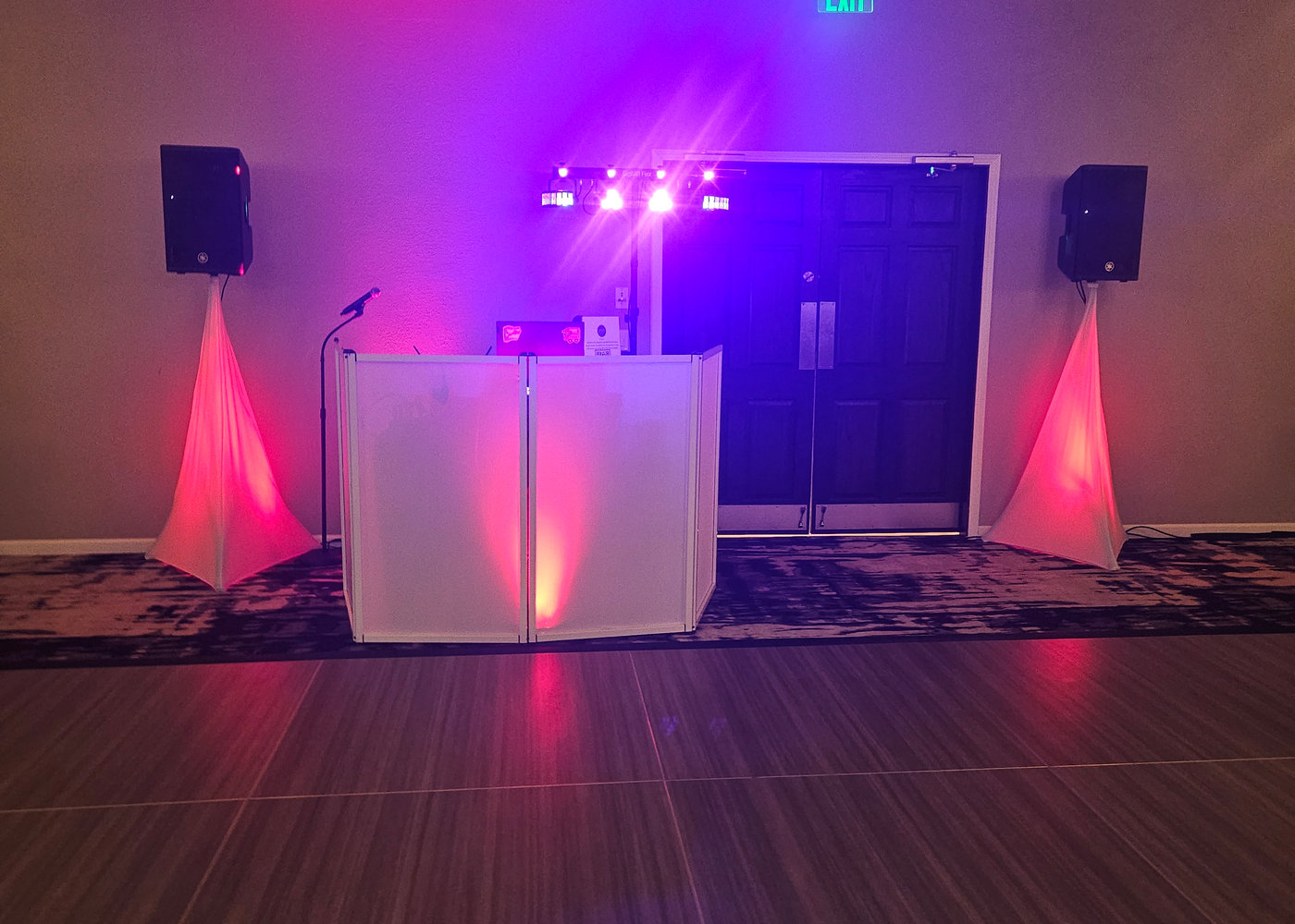 Lex-G's white booth and scrims with pink uplighting and truss-mounted dance floor lights